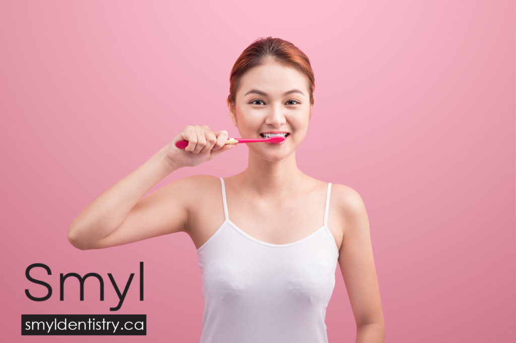 A woman brushing her teeth